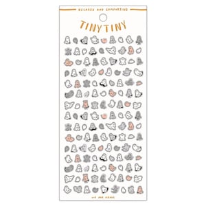 May include: A sheet of stickers featuring a variety of cute ghost illustrations in shades of gray and pink. The stickers are arranged in rows on a white background. The text "Tiny Tiny" is printed at the top of the sheet, and the text "We are Obake" is printed at the bottom.