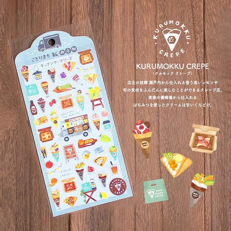 May include: A sheet of colorful stickers featuring a food truck selling crepes. The stickers include various illustrations of crepes, fruits, and other food items. The text on the sheet reads "Kitchen Car Series" and "Kurumokku Crepe".