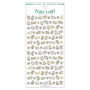 May include: A sheet of stickers featuring a variety of cute cats in different poses. The cats are drawn in a simple, cartoon style and are colored in shades of green, yellow, and orange. The stickers are arranged in a grid pattern on a white background. The text "Tiny Tiny" and "We Are Tora" are printed on the sheet.