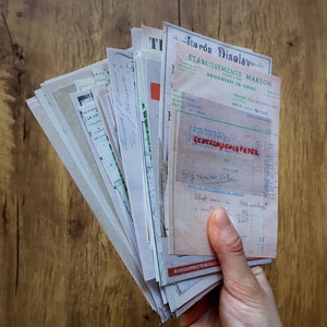 May include: A stack of vintage paper documents with a handwritten receipt from a French pharmacy called "&Eacute;tablissements Marton" for "G&eacute;ocalogicols Paper". The receipt is dated and includes a handwritten total of 562.