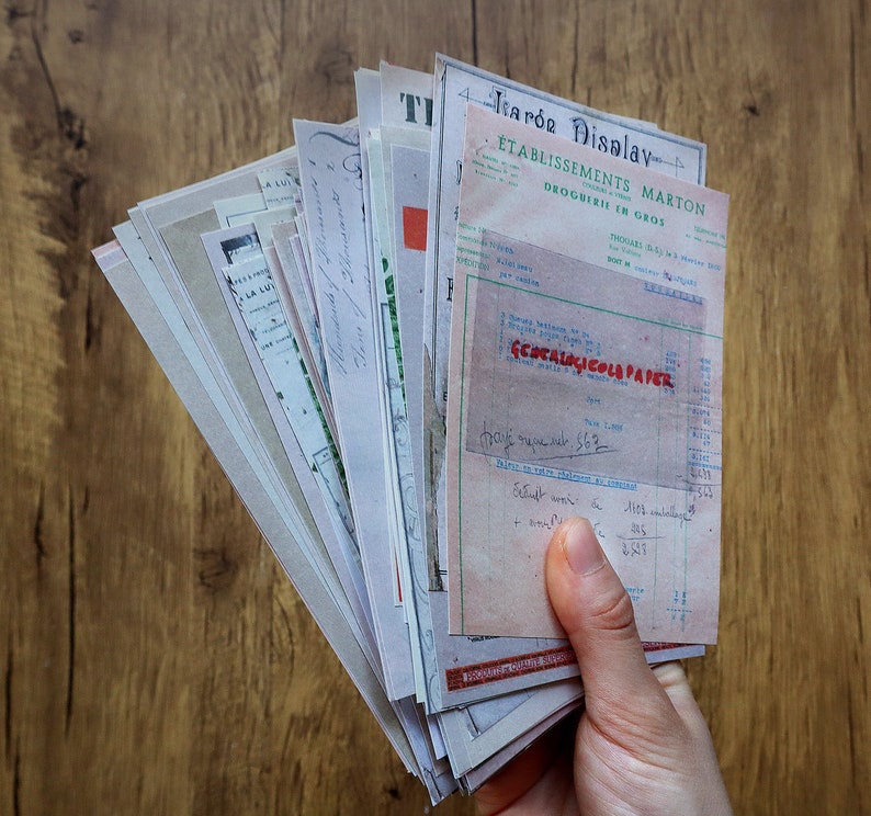 May include: A stack of vintage paper documents with a handwritten receipt from a French pharmacy called "&Eacute;tablissements Marton" for "G&eacute;ocalogicols Paper". The receipt is dated and includes a handwritten total of 562.