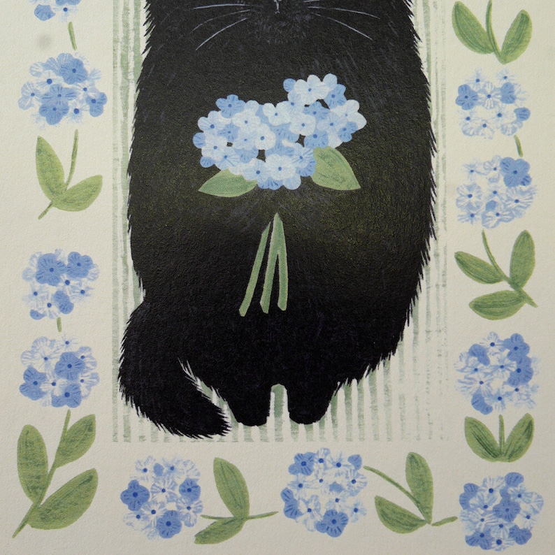 May include: A black cat holding a bouquet of blue flowers. The cat is sitting on a white background with green stripes. The flowers are surrounded by a border of blue flowers and green leaves.
