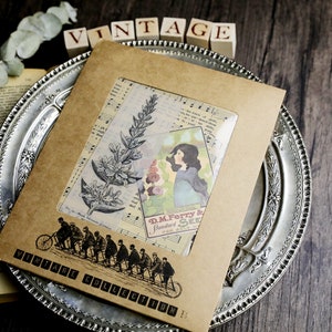 May include: A brown paper envelope with a clear window showing vintage ephemera, including a floral illustration, a woman's portrait, and a music sheet. The envelope has a vintage stamp that reads "Vintage Collection B".