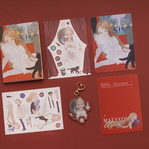Op de afbeelding: Een set met schrijfwaren met illustraties van een jonge vrouw met lang blond haar en een zwarte kat. De set bevat een notitieboekje, stickers, een sleutelhanger en een kaart met de tekst "MIYOPAI MATAYOSHI".