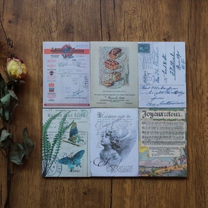 May include: Six vintage postcards with various designs. The postcards feature images of butterflies, flowers, a musical score, a handwritten note, and a bakery. The text on the postcards includes "Laboratories Lepas", "Epicerie Elion", "Condition rigde be", "Mrs Gotterelam", and "Joyeuxretour."