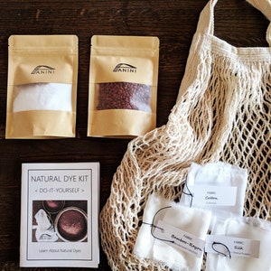 May include: Natural dye kit with instructions, two bags of dye, a mesh bag, and three fabric swatches labeled "Cotton", "Bamboo-Rayon", and "Silk".