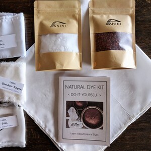 May include: Natural dye kit with instructions, two bags of dye, and four fabric swatches labeled "Cotton", "Bamboo-Rayon", and "Silk".