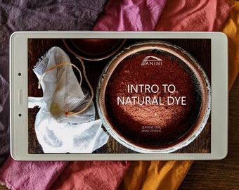 May include: A tablet screen displaying a natural dye workshop course titled "Intro to Natural Dye" by Jeanne Ertl, Anni Designs. The screen is surrounded by fabric swatches in various shades of red, orange, and brown.