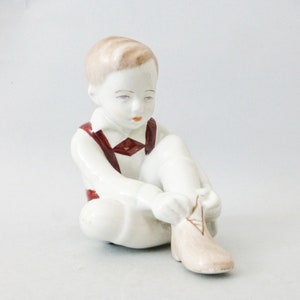 Vintage Hungarian Porcelain Child Figurine: Hand-Painted Dressing Boy