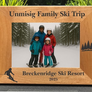 May include: A wooden picture frame with a family photo on a ski trip. The frame has the text "Unmisig Family Ski Trip" and "Breckenridge Ski Resort 2025". A skier silhouette and tree graphic are also on the frame.