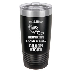 May include: Black stainless steel tumbler with a silver lid. It has a white graphic of a running shoe with wings and the text "Goshen Redskins Track & Field Coach Hicks".