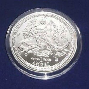 a silver coin on a blue surface