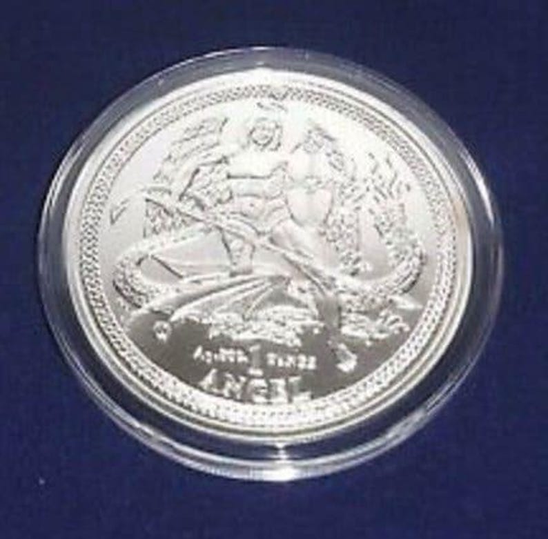 a silver coin on a blue surface