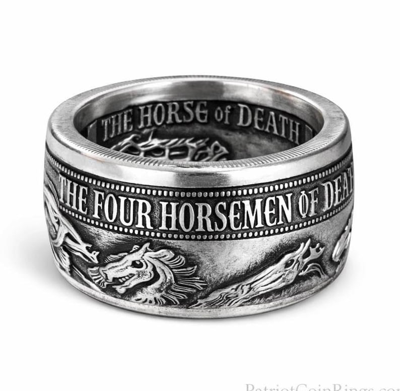 A silver ring with a detailed engraved design featuring a dragon and the text "THE FOUR HORSEMEN OF DEATH".