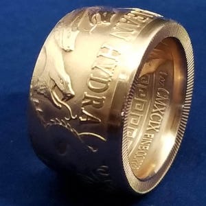 a close up of a gold ring on a blue surface