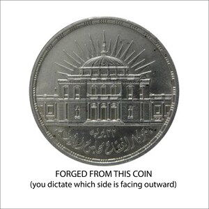 A coin with an intricate design depicting a building, and the text "FORGED FROM THIS COIN (you dictate which side is facing outward)" is displayed.