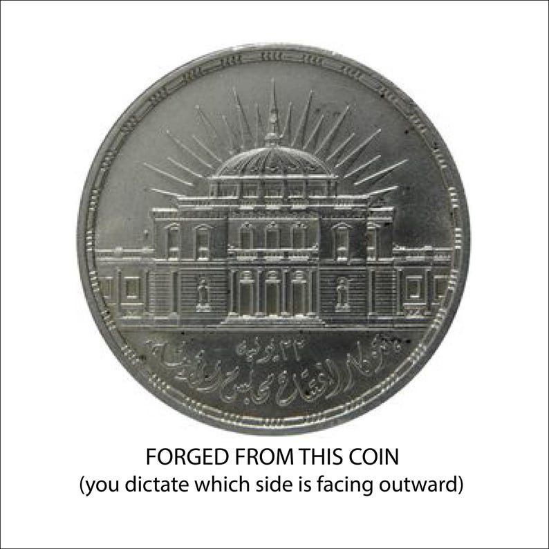 A coin with an intricate design depicting a building, and the text "FORGED FROM THIS COIN (you dictate which side is facing outward)" is displayed.
