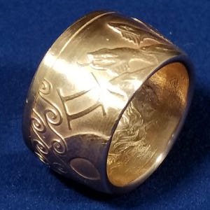 a close up of a gold ring on a blue surface
