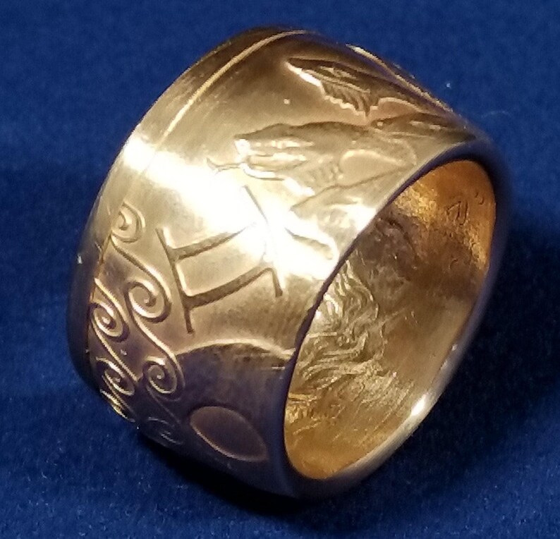 a close up of a gold ring on a blue surface