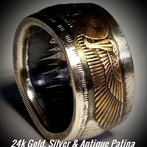 a gold and silver ring with an eagle on it
