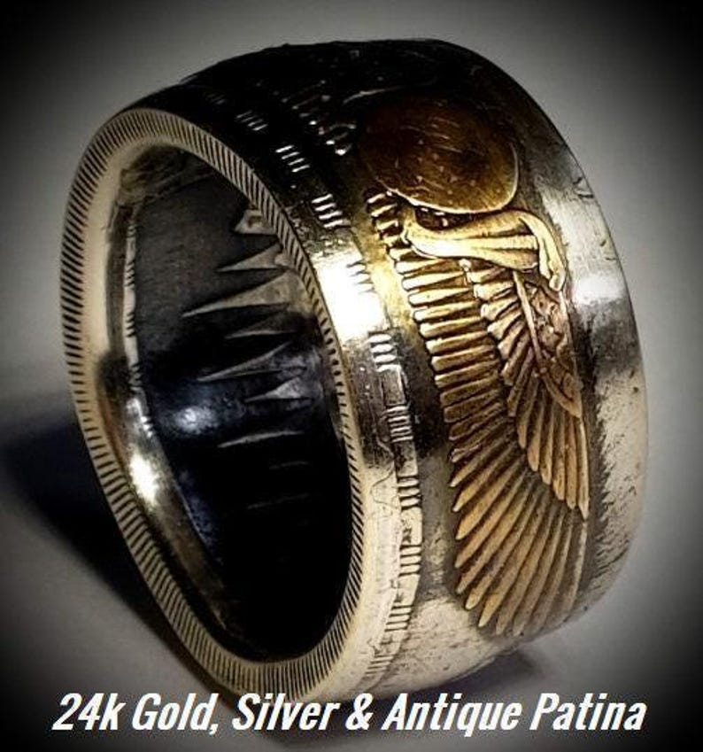 a gold and silver ring with an eagle on it