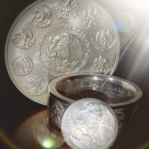 a couple of silver rings sitting on top of a table
