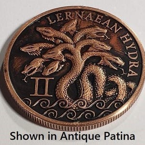 a close up of a coin with a tree on it