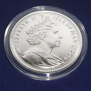 a silver coin on a blue surface