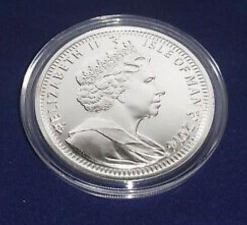 a silver coin on a blue surface