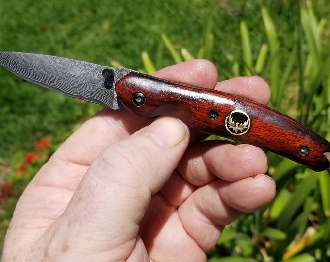 DAMASCUS POCKET KNIFE w/ Ebony Rosewood, Deep Etch, Phoenix insignia, Tactical Matte Black Backbone, Fast Flip Open, Safety Lock, Lanyard.