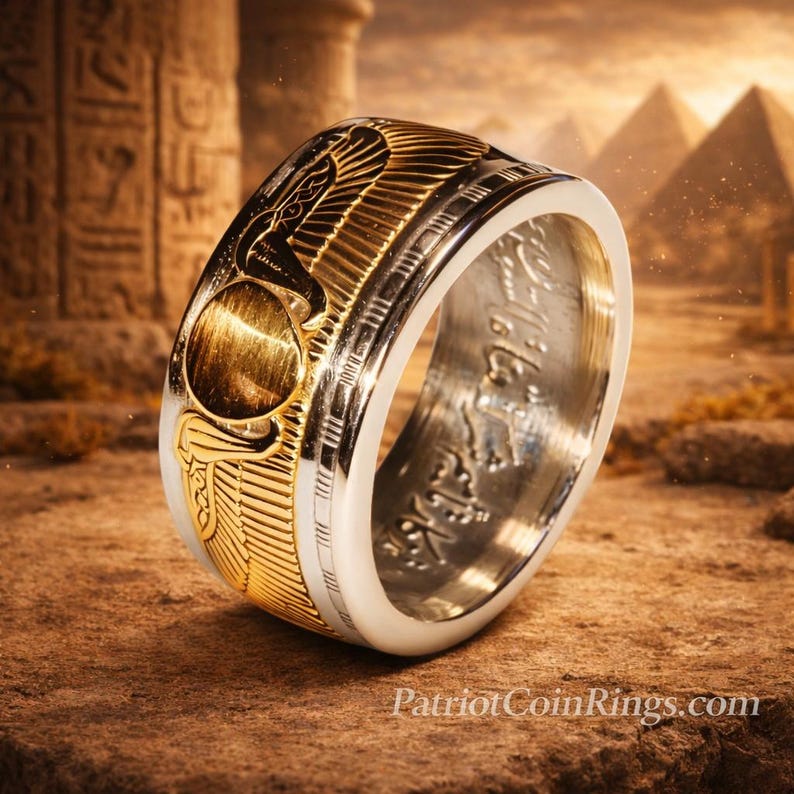 A gold and silver ring with intricate designs, placed on a rock against a backdrop of ancient Egyptian ruins and pyramids.