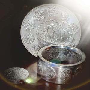 a couple of silver rings sitting on top of a table