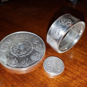 a silver coin sitting on top of a wooden table