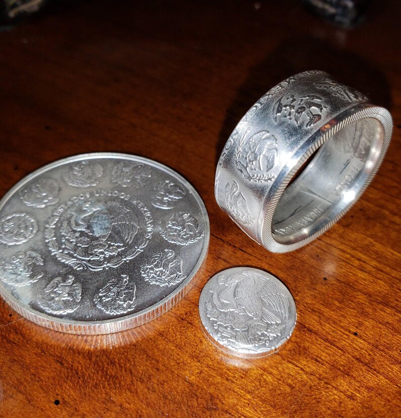 a silver coin sitting on top of a wooden table