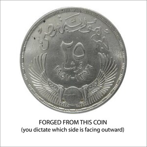 A coin with a winged design and Arabic script, indicating it is a coin that has been forged from it.