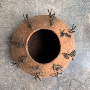 Felted vessel, pure wool, brown fine wool with rows of stems on the outside.