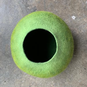 Felted vessel. Pure wool. Bright green colors transitioning from bright on the top to darker on the bottom.