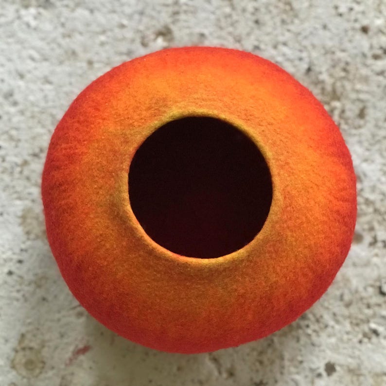 Felted vessel, pure wool, in orange colors transitioning from yellow to dark orange.