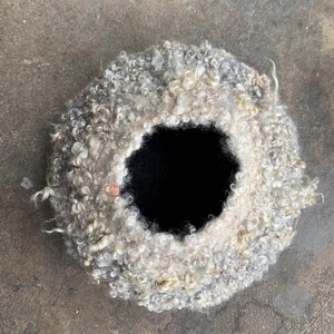 Felted vessel, pure wool. Felted with raw wool on the outside, white and grey curls.
