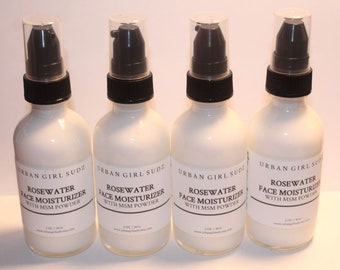 May include: Four white bottles of rosewater face moisturizer with black pump tops and labels that read "Urban Girl Sudz Rosewater Face Moisturizer with MSM Powder".