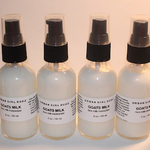 May include: Four clear glass bottles with black pump tops filled with a white liquid. Each bottle has a white label with the text "URBAN GIRL SUDZ" and "GOATS MILK face milk moisturiser 2 oz./60 ml."