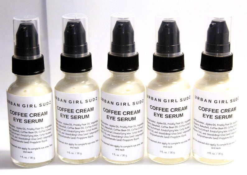 May include: Five 1 fl oz / 30 g bottles of Urban Girl Sudz Coffee Cream Eye Serum. The bottles are white with black lids and labels. The labels have the brand name, product name, and ingredients.
