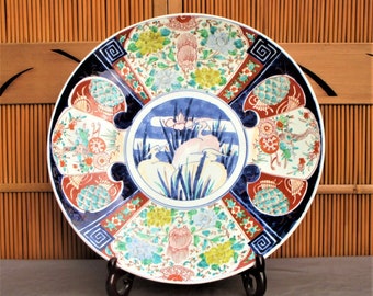 Large 18" antique Japanese Imari charger, with bright, beautiful hand painted herons, turtles, flowers, handmade, mingei art, with stand