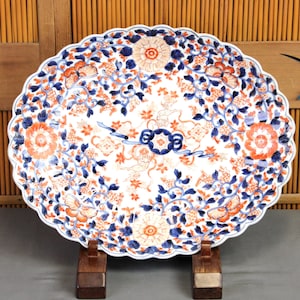 Large oval antique Japanese Imari porcelain charger, 17'5", foliated, fluted, very colorful, gilded, butterflies, shishi, blossoms, Meiji