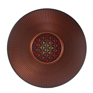 May include: A round, wooden wall hanging with a red, orange, and yellow geometric design in the center. The design is surrounded by a black circle and the outer edge of the wall hanging is a dark red color.