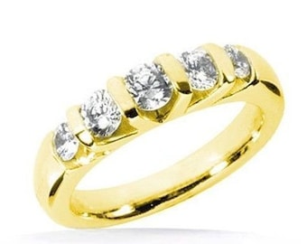 May include: A gold band ring with five round diamonds set in a row.