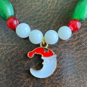Festive Christmas Bracelet with White, Red, and Green Beading and Santa Charms