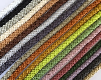 May include: A collection of 20 different colored braided cords. The cords are arranged in a diagonal pattern, with the lightest colors at the top and the darkest colors at the bottom.
