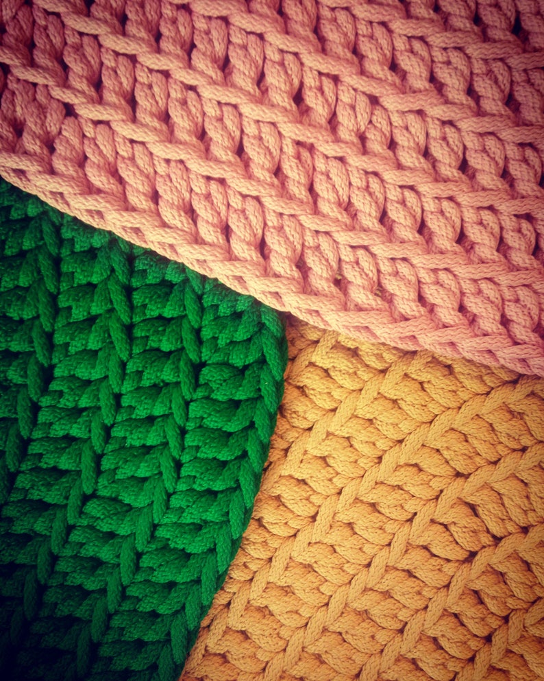 May include: Three sections of knitted fabric in different colors: pink, green, and yellow. The fabric is woven in a simple, repeating pattern.