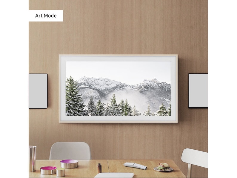 May include: A white framed television displaying a snowy mountain scene with the text "Art Mode" in the top left corner.
